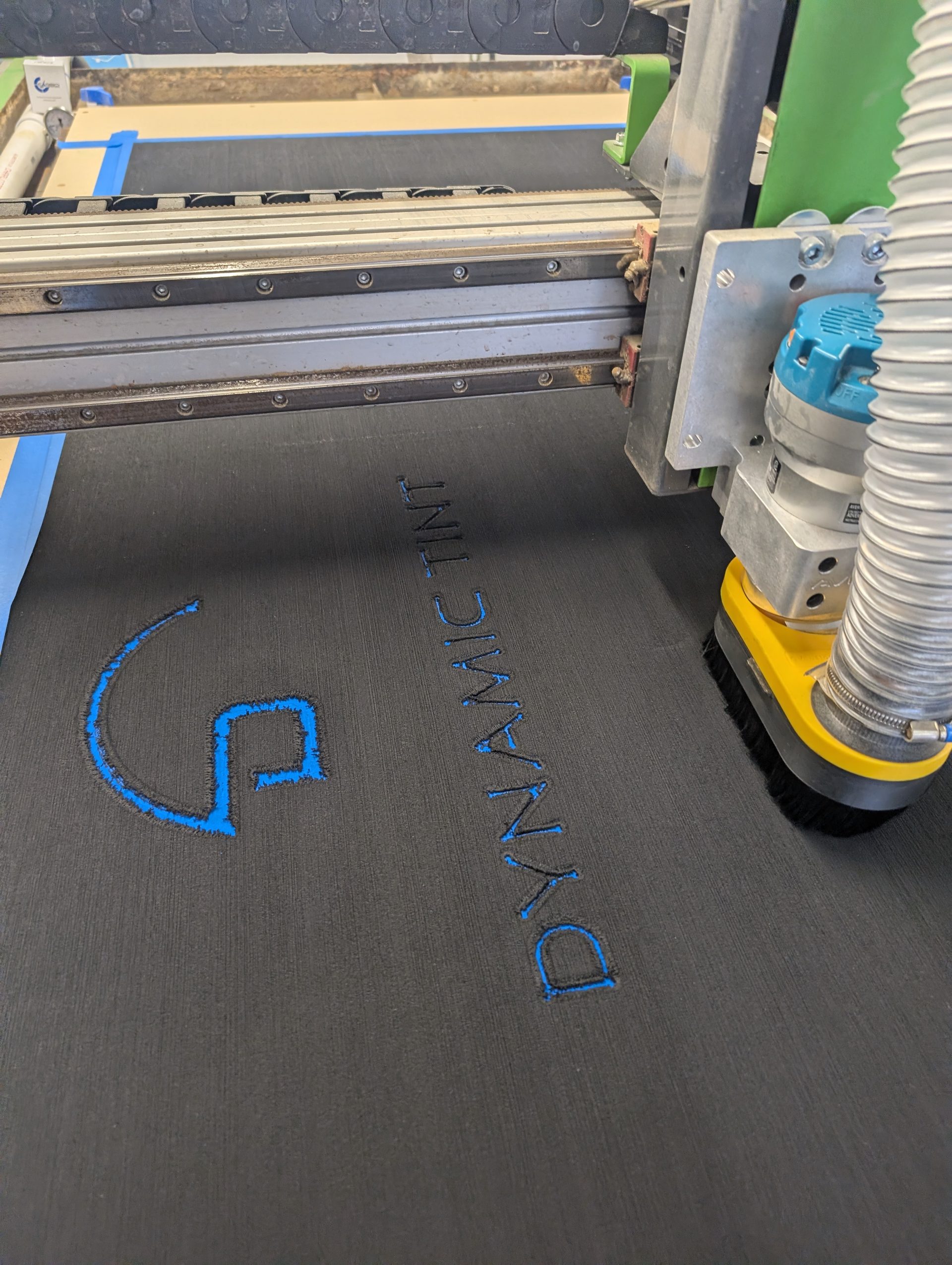 Lettering being routed into foam on the CNC table